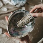 person holding blue and brown paint